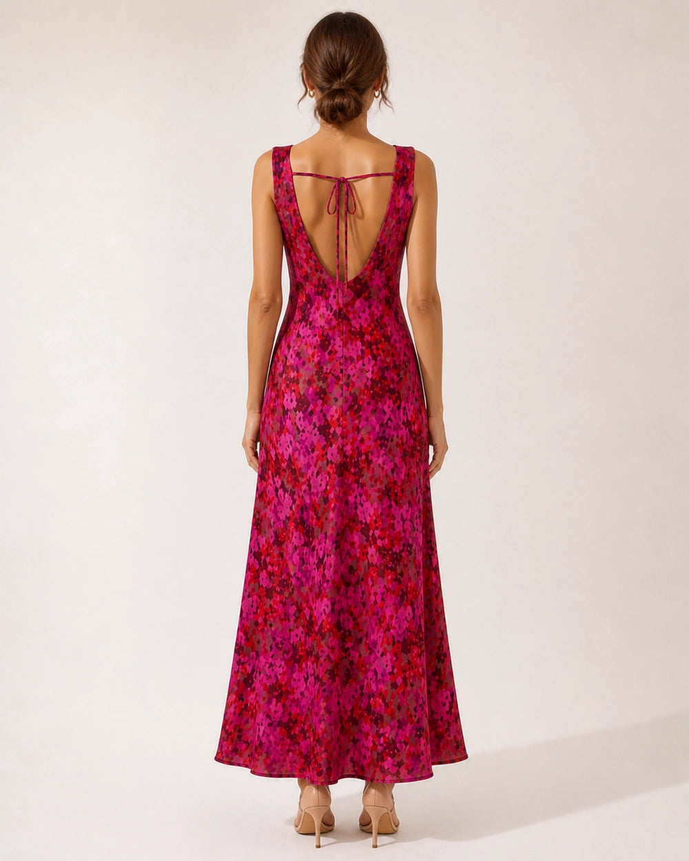 Women's pink floral sleeveless cowl-neck bias-cut maxi dress, open-back view.