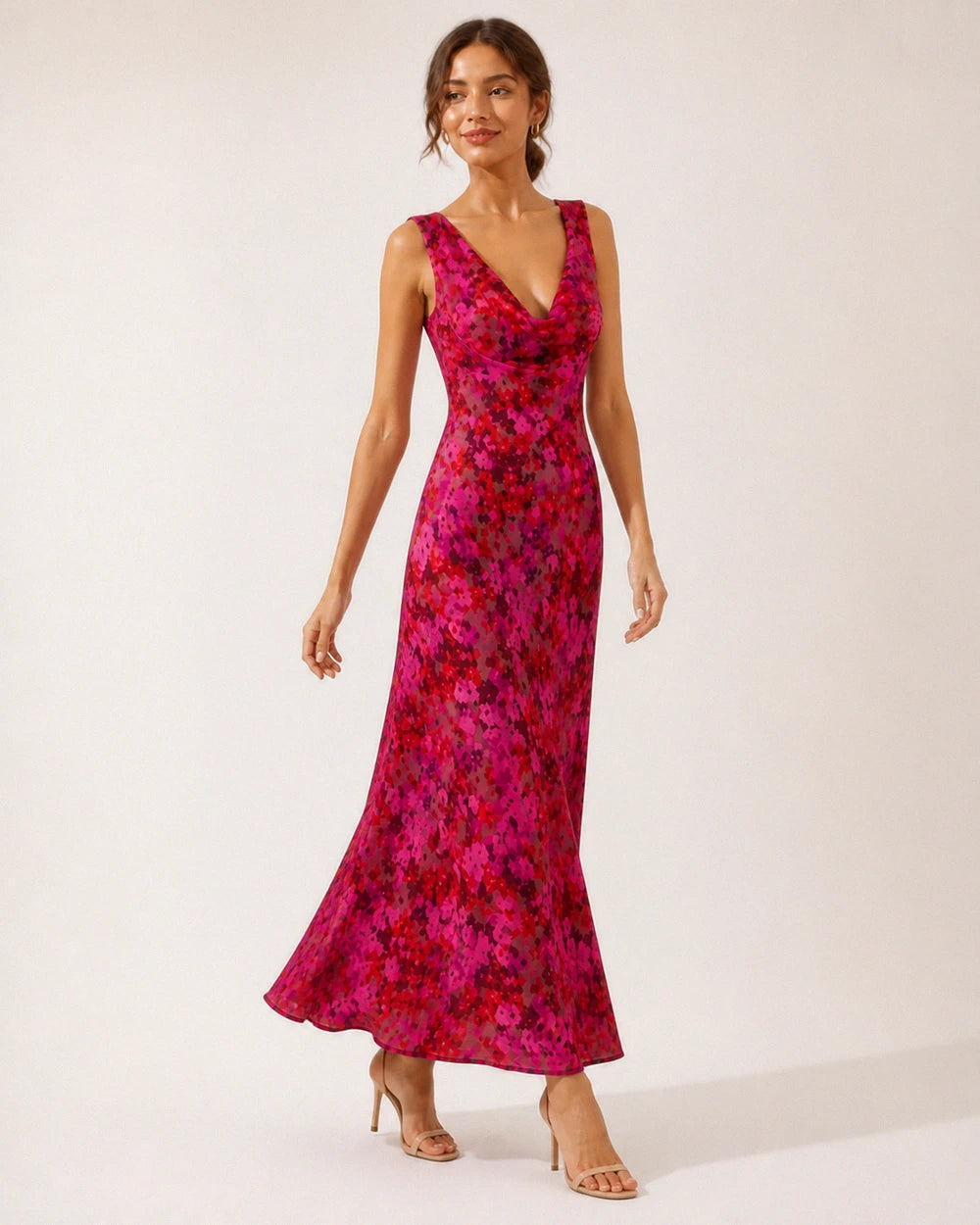 Women's pink floral sleeveless cowl-neck bias-cut maxi dress, walking movement view.