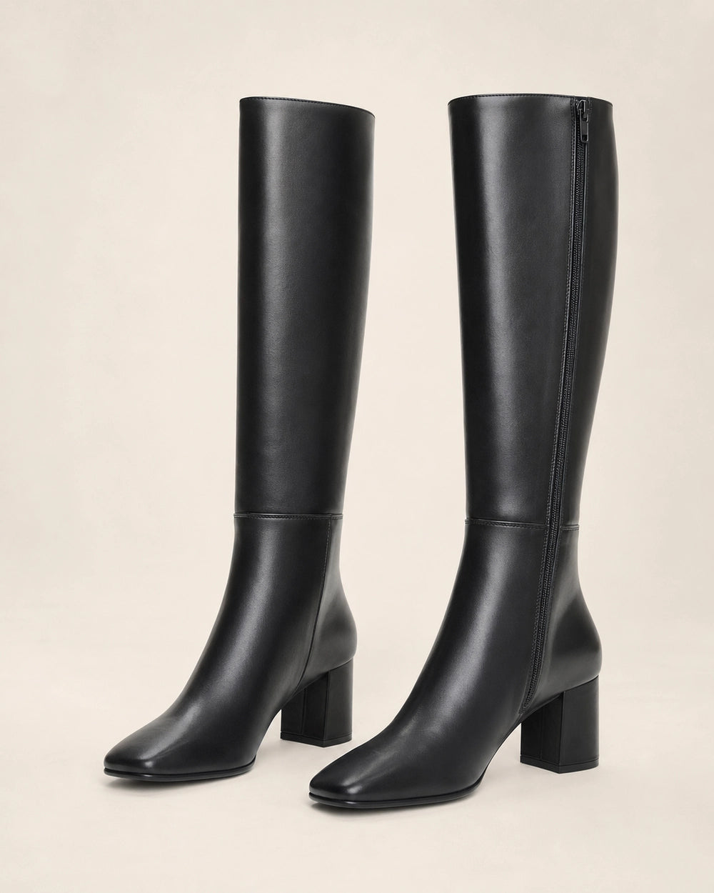 Women's black knee-high broad-heel boots, product-only pair.